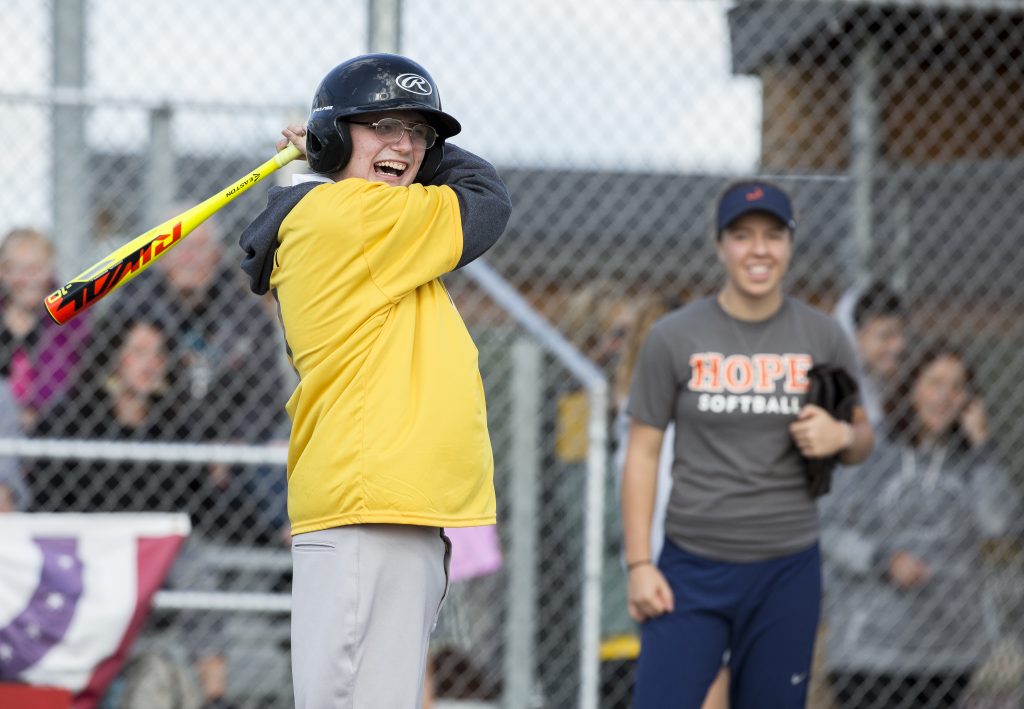 Claire Bates looks on as a Miracle League player gets ready to bat.
