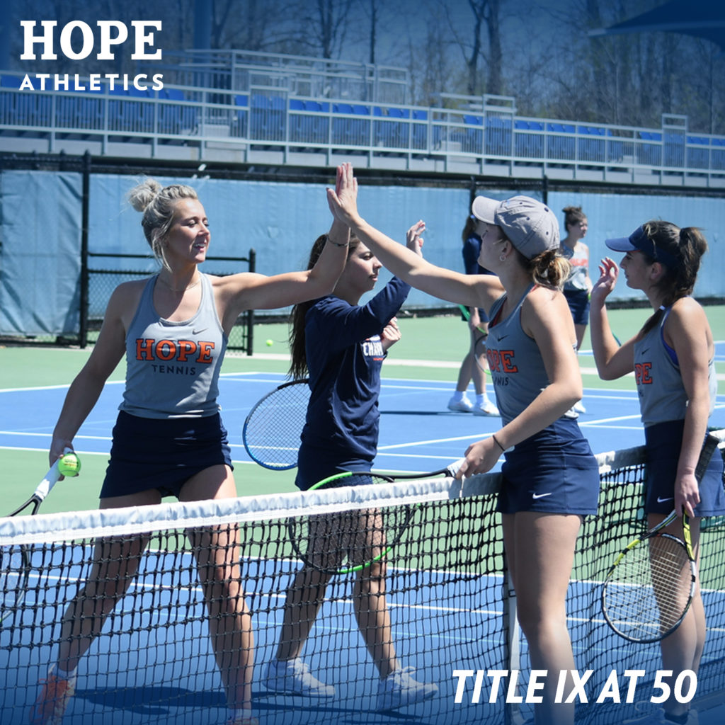 Four Hope College women's tennis teammates high five on the court.