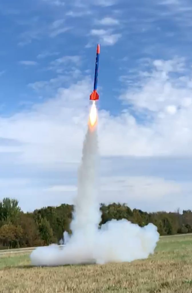 Orange and blue, 5 foot rocket several yards in the air