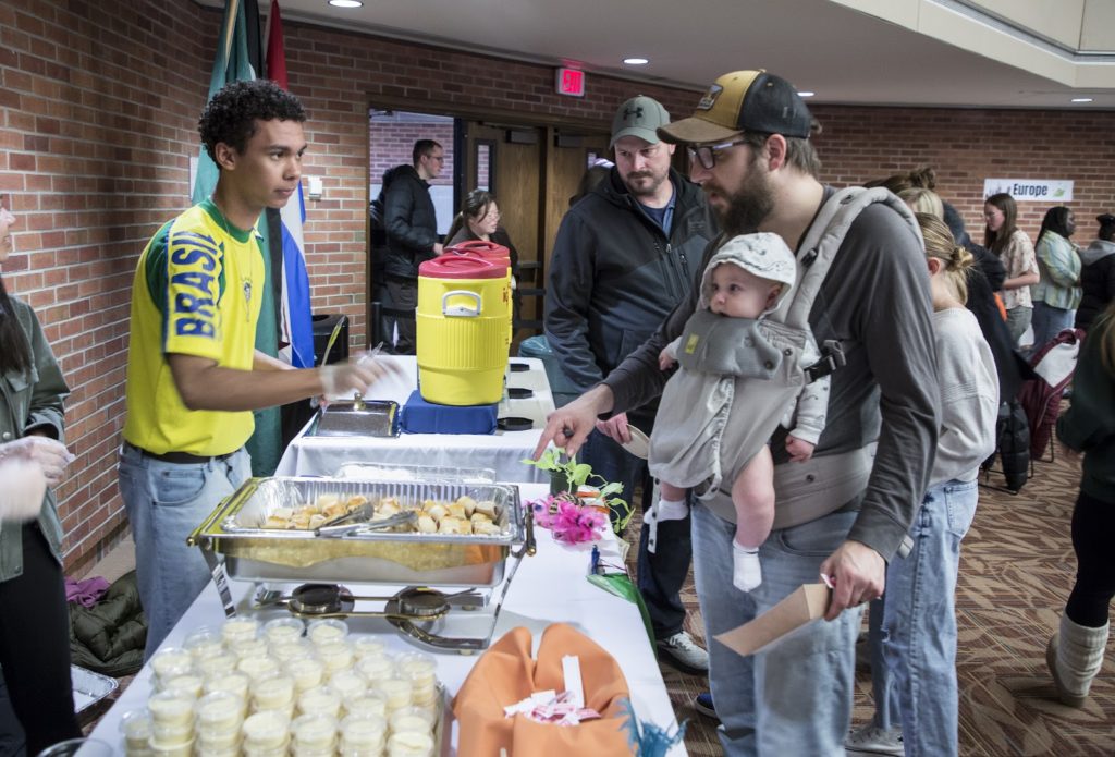 A student from Brazil serves Brigadeiro, Mousse de Marácuja, Bolo de Fubá com goiabada 