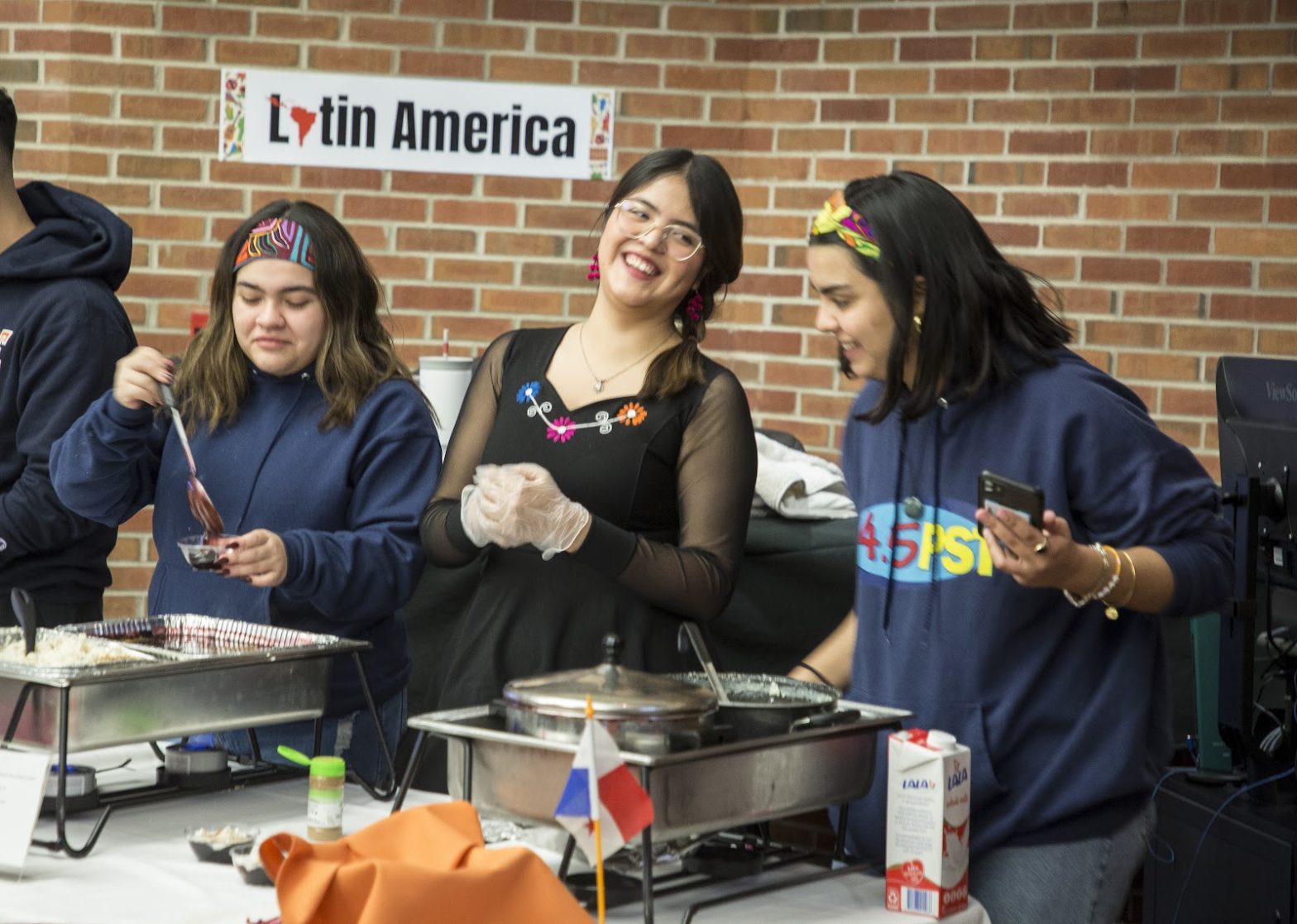 Three students from Peru share food at the Hope College International Food Festival