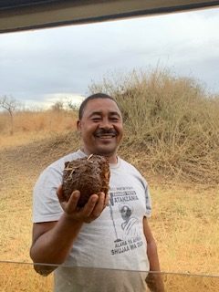 Our guide Serafino, holding a handful of elephant dung. Many Tanzanians believe mixing this in water and drinking it is a good cure for high fever and stomachaches due to all the fiber in it... I personally prefer ibuprofen and a nap, but to each their own!