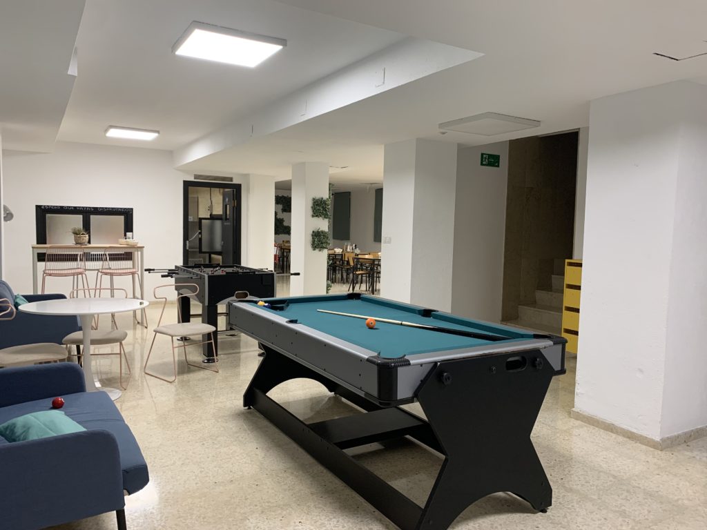 Our foosball and pool table available to play anytime that lead into the dining hall