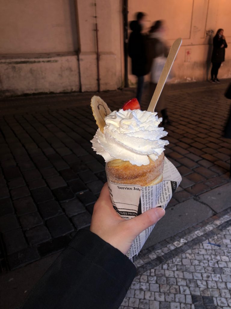 Trdelnik with whipped cream and strawberries in Old Town, Prague