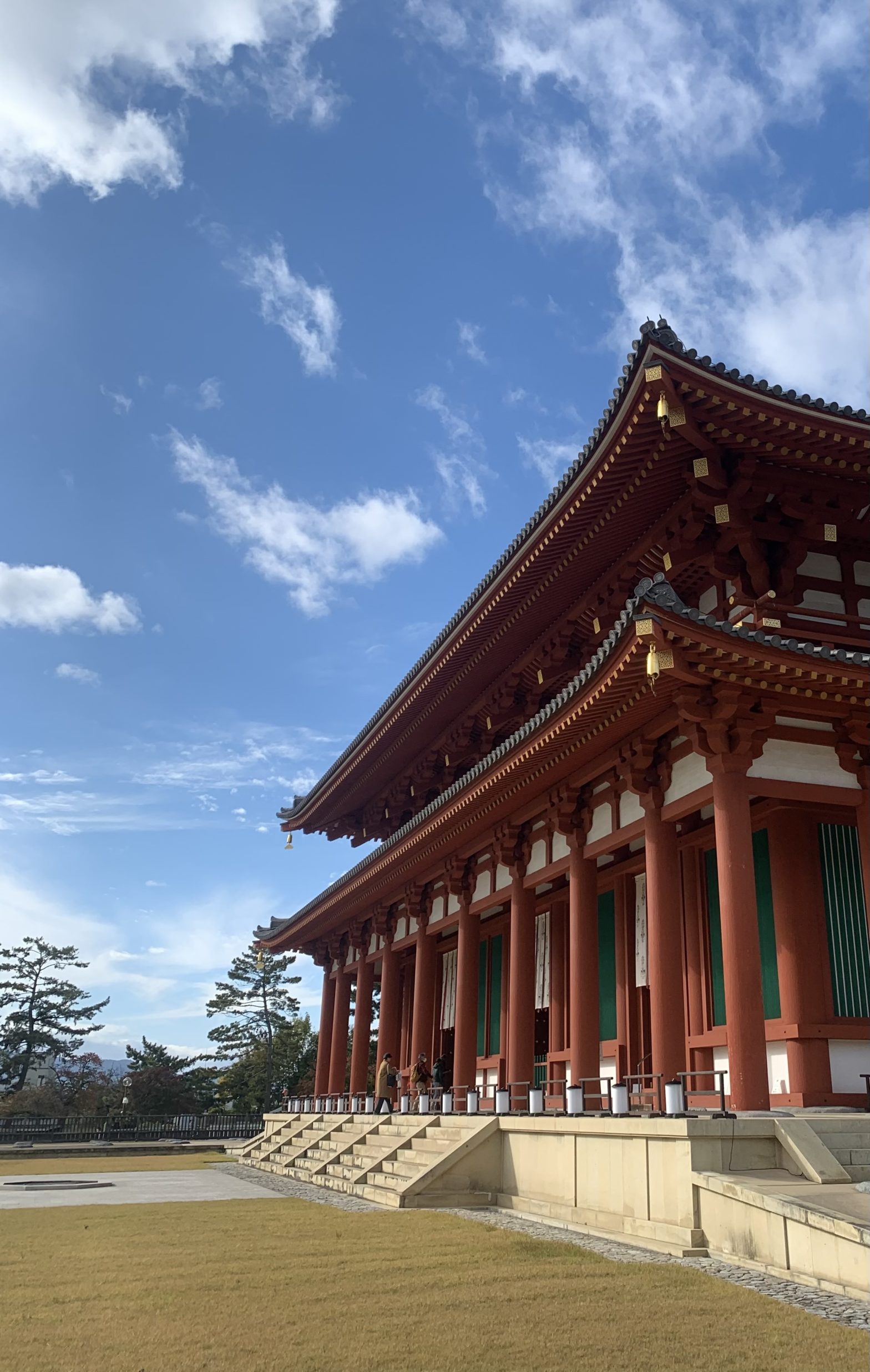 Kofuku-ji Buddhist temple main hall. Side view of a red elevated building with a blue sky background.