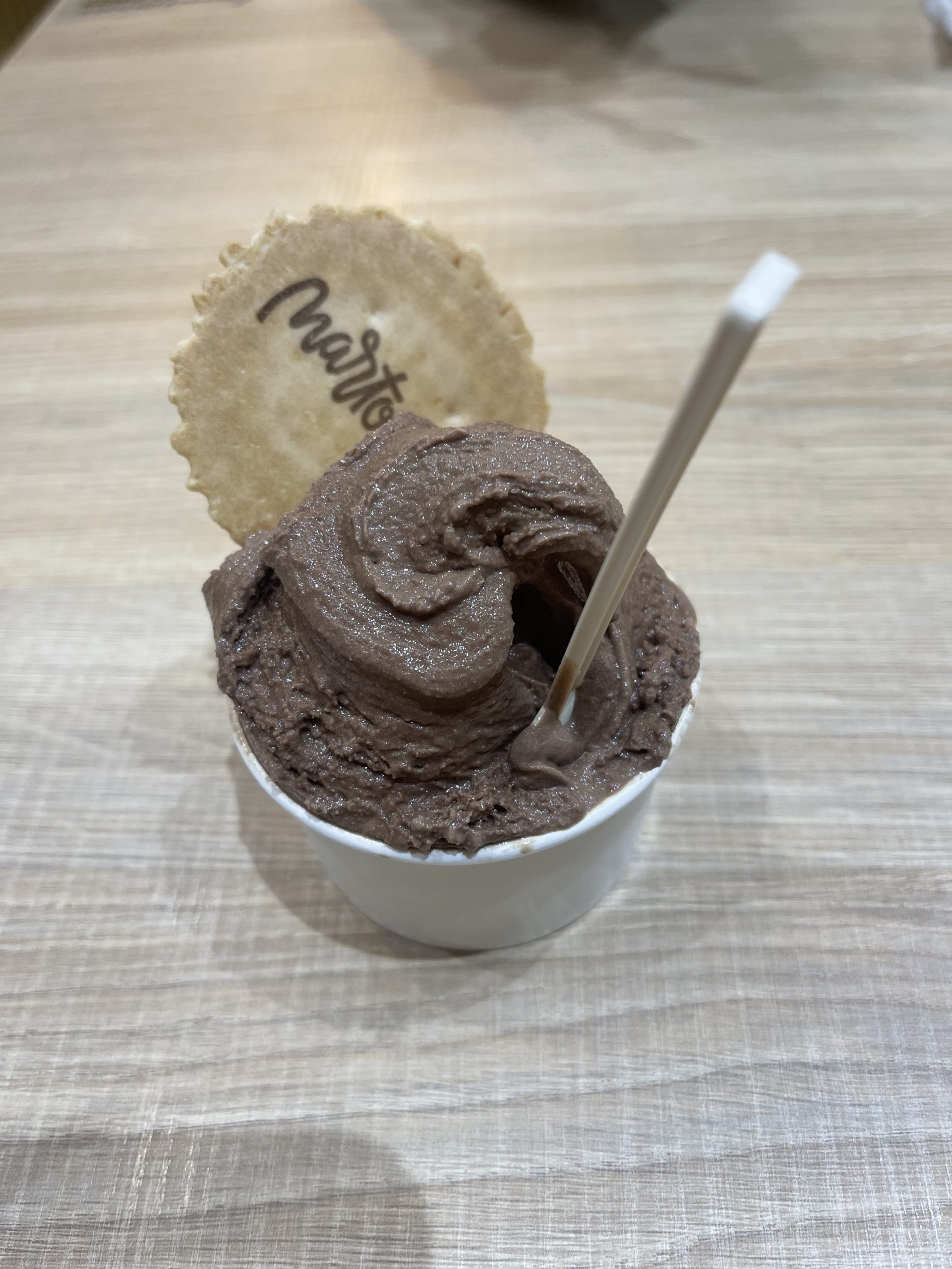 A picture of chocolate ice cream with a wafer.