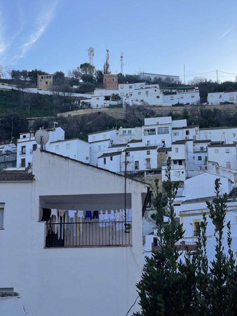 A picture of many white houses climbing up a mountain. 
