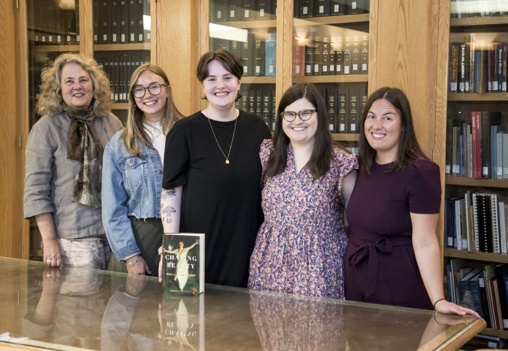 Emerita English professor Dr. Natalie Dykstra with the four graduates who participated in the September panel discussion about their experiences as students conducting research for her book Chasing Beauty: The Life of Isabella Stewart Gardner. From left to right are Dykstra, Melanie Burkhardt ’18, Hannah Jones ’21, Aine O’Connor ’20 and Sarah Lundy ’19.