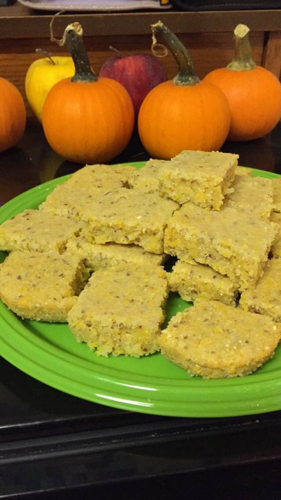 cornbread on a plate with mini pumpkins in the background