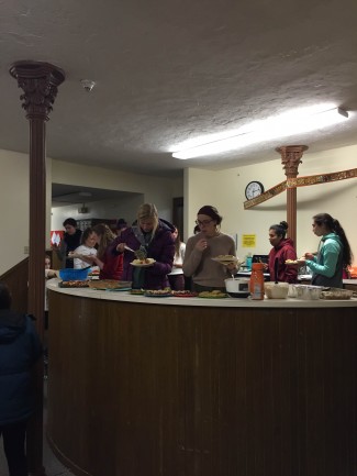 Van Vleck residents filling plates of food in the basement