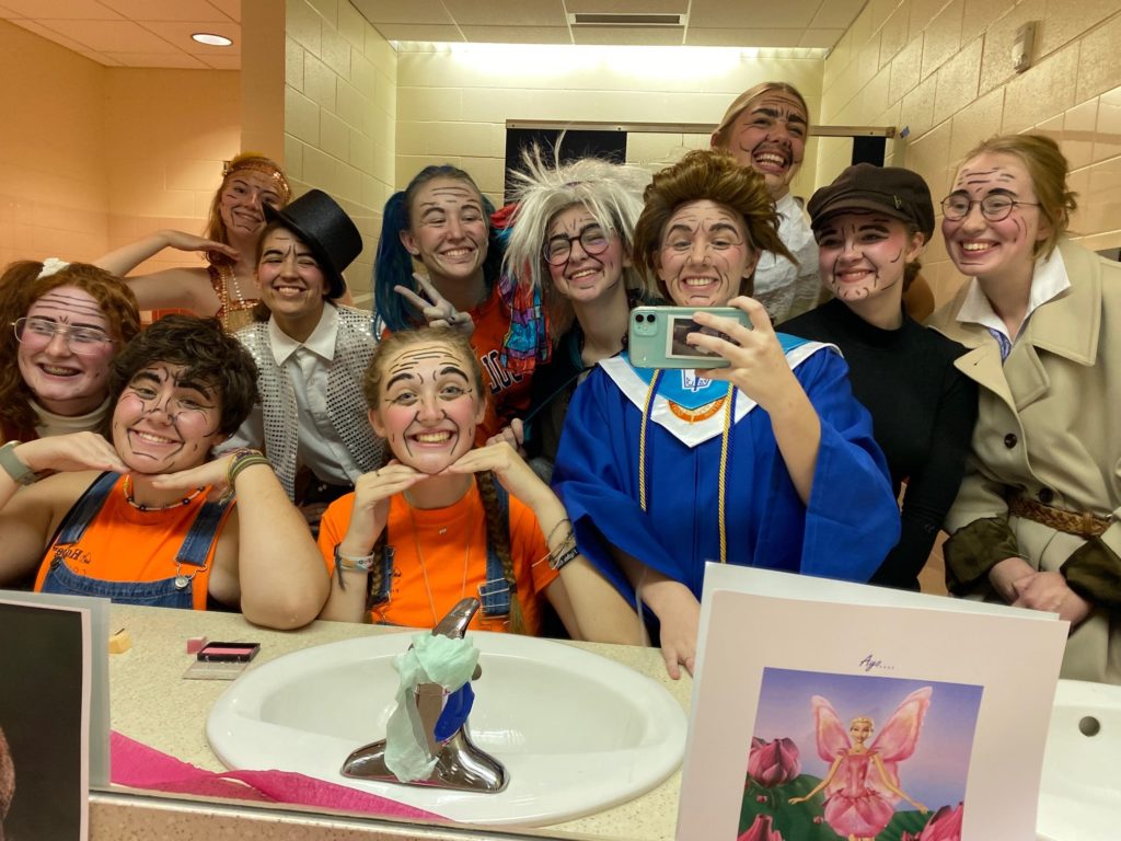 The even year play cast in costume before the performance. 
