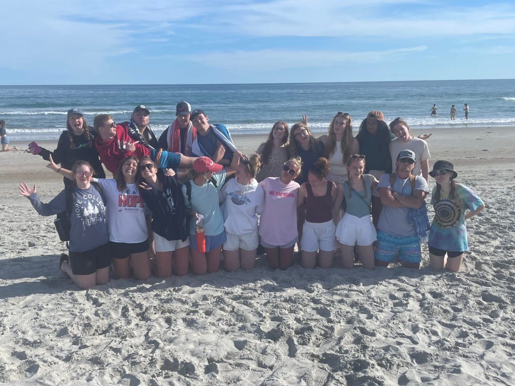 Hope College students pose on a beach during their immersion trip.