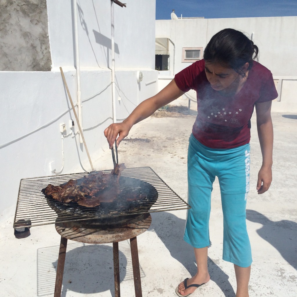 My host sister preparing the barbecue for lunch.